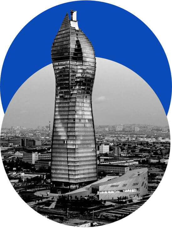 Photograph of a skyscraper with a blue circle behind it.