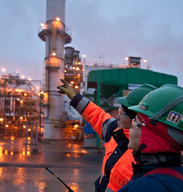 Photograph two workers pointing/looking.'